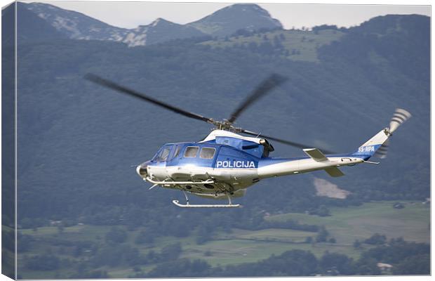 Police helicopter patrolling Canvas Print by Ian Middleton
