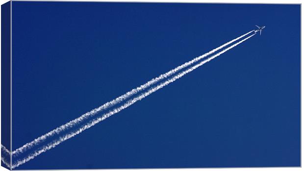 Airplane trail in blue sky Canvas Print by patrick dinneen