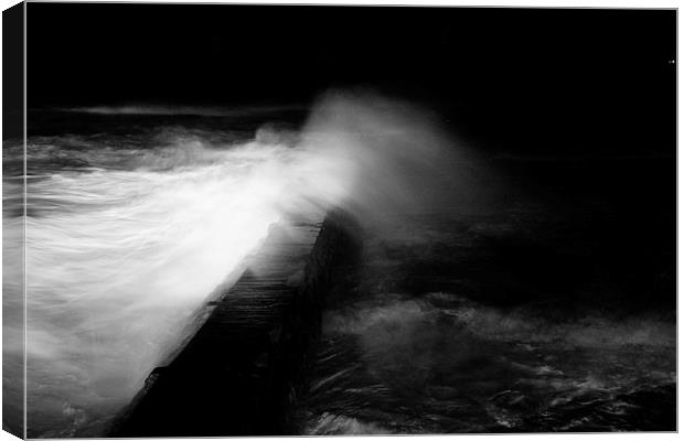 waves smashing over harbour wall Canvas Print by jon betts