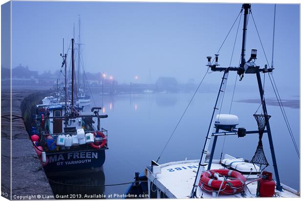 Fishing boats and fog over harbour at dawn. Wells- Canvas Print by Liam Grant