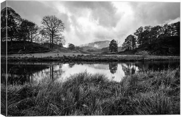 Dramatic sky and reflections on the River Brathay  Canvas Print by Liam Grant