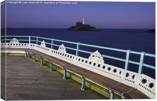 Lighthouse at dusk from Mumbles Pier. Wales, UK. Canvas Print by Liam Grant