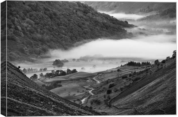 Fog formed in the valley at sunrise. Kirkstone Pas Canvas Print by Liam Grant