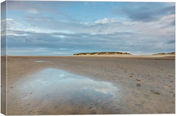 Sunset sky reflected in a water at low tide. Wells Canvas Print by Liam Grant