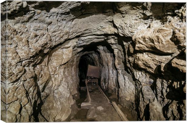 Mine cart in an old abandoned mine cave. Near Matl Canvas Print by Liam Grant
