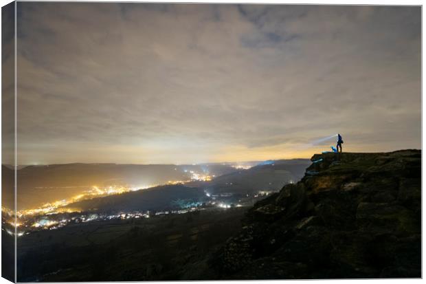 Male and his dog, standing on Curbar Edge at night Canvas Print by Liam Grant