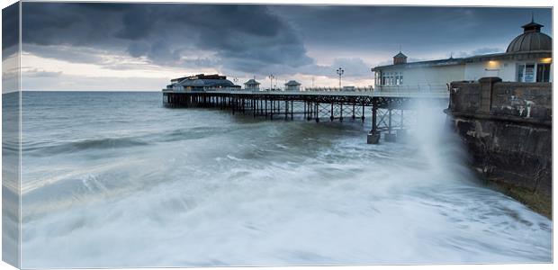 Cromer Pier high tide Canvas Print by Simon Wrigglesworth