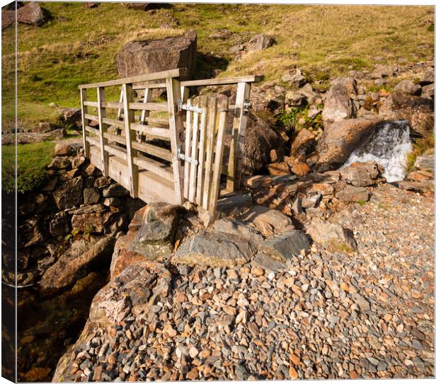 Bridge Over Stream Canvas Print by Simon Wrigglesworth