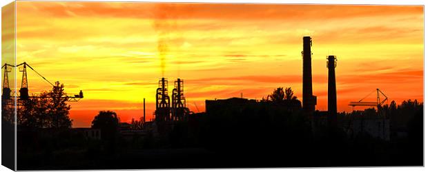 Smoking factory chimnies at sunset Canvas Print by Ray Fidler