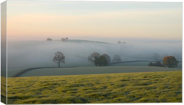 Hill tops in the mist Canvas Print by Pete Hemington
