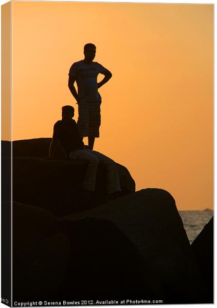 Silhouetted Figures on Rock at Sunset Palolem Canvas Print by Serena Bowles