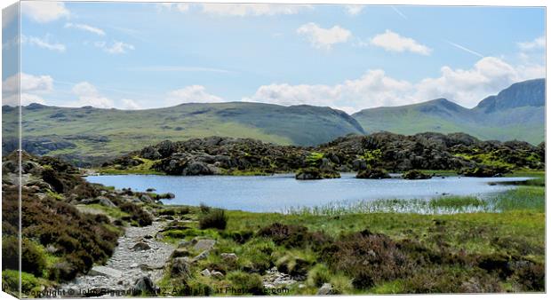 Haystacks tarn Canvas Print by John Biggadike