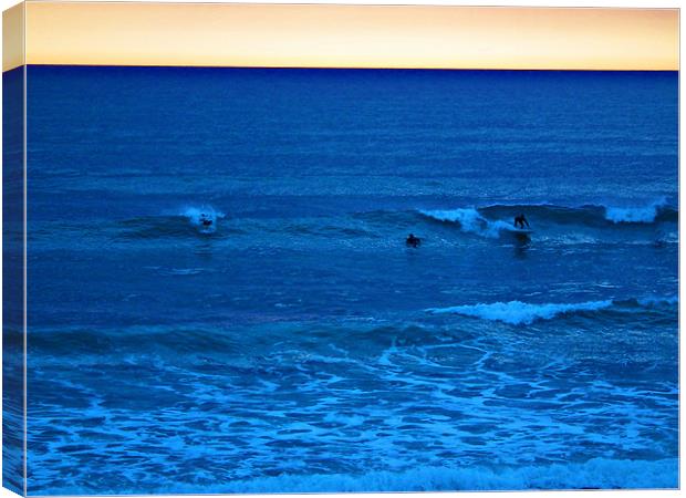 Sunset Surfers Canvas Print by Jules Camfield