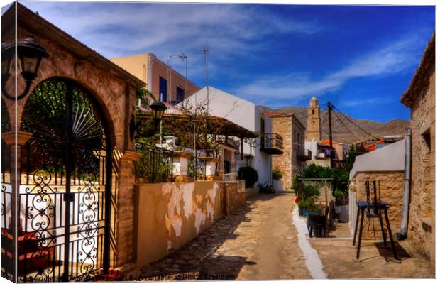 Between the Houses in Halki Canvas Print by Tom Gomez