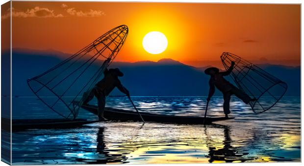 Burmese Fishermen In Silhouette Against The Sunrise Canvas Print by Chris Lord