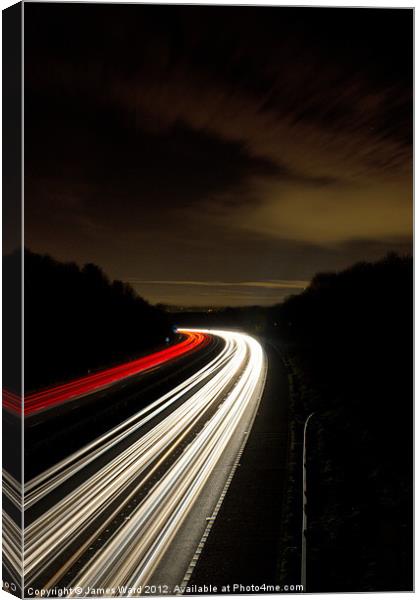 Motorway light trails at Crawley, Sussex Canvas Print by James Ward