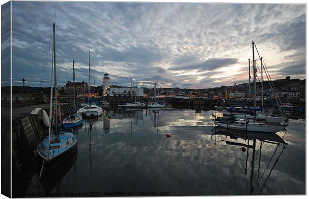 Across the harbour at dusk Canvas Print by Stephen Wakefield