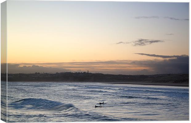 Surfing at Daybreak Canvas Print by Kieran Brimson