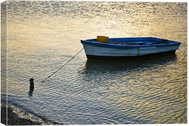 boat tied Canvas Print by Hassan Najmy