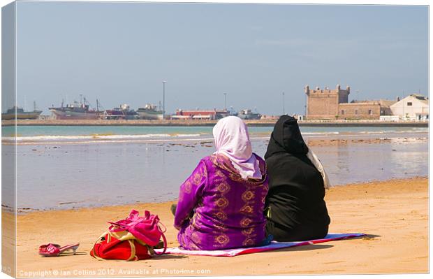 Moroccan women on beach Canvas Print by Ian Collins