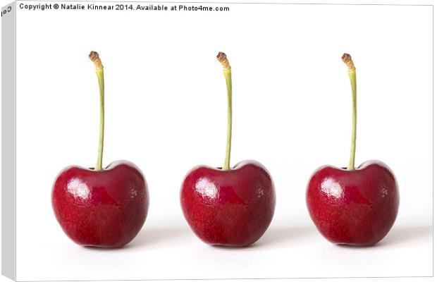 Three Red Cherries against a White Background Canvas Print by Natalie Kinnear