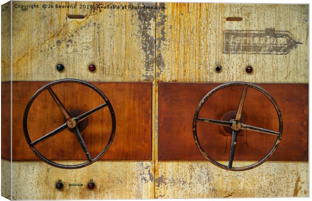 rusty wheels Canvas Print by Jo Beerens