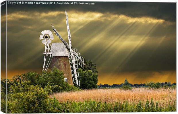 windmill with sunbeams Canvas Print by meirion matthias