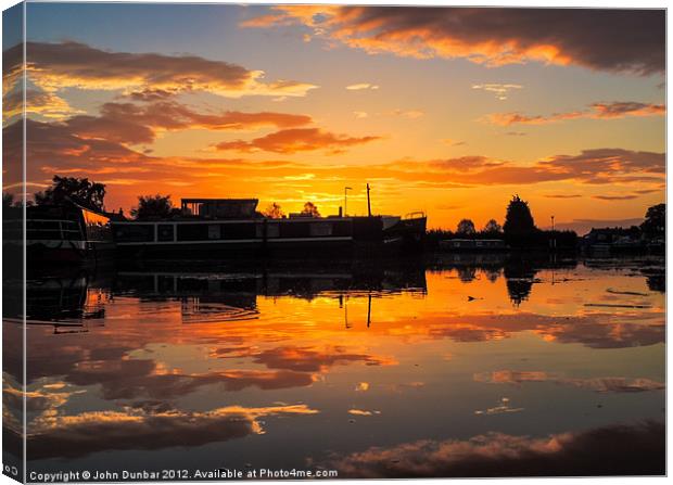 Sunrise arcross the water Canvas Print by John Dunbar