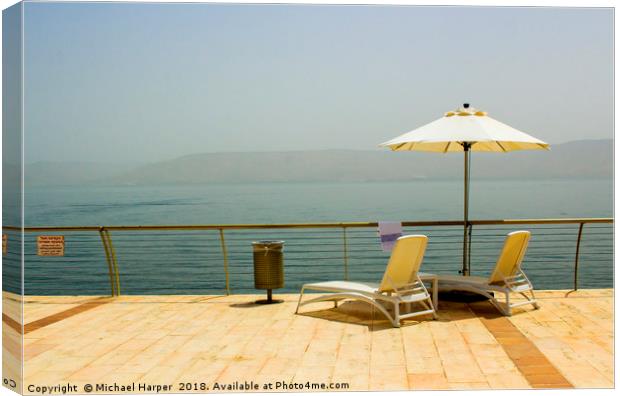 Sun beds and Brolly on the shores of Galilee Canvas Print by Michael Harper