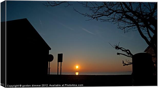 Sunrise and silhouettes at Calshot Canvas Print by Gordon Dimmer