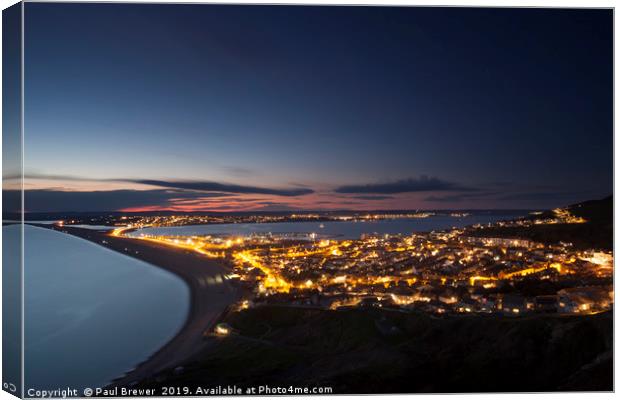 Portland at night looking towards Weymouth Canvas Print by Paul Brewer