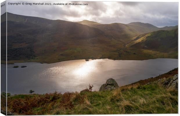 Sun breaks over icy looking Crummock Water from Rannerdale Knotts Canvas Print by Greg Marshall