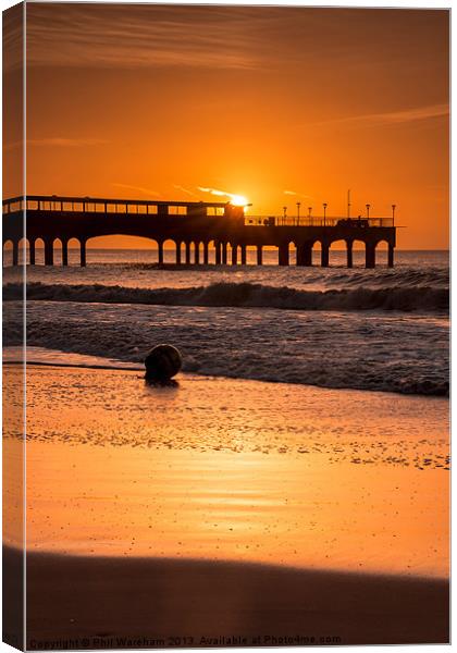 Sunrise over the pier Canvas Print by Phil Wareham