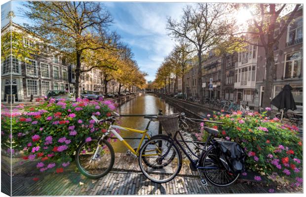 Iconic Amsterdam canal view with bicycle parked be Canvas Print by Ankor Light