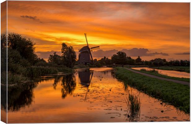 Windmill at the warm and red color sunrise in Haze Canvas Print by Ankor Light