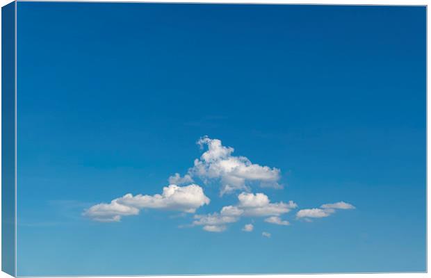 Group of clouds floating in the blue cyan sky Canvas Print by Ankor Light