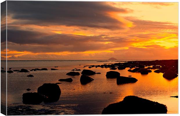 sunset and rocks Canvas Print by jane dickie