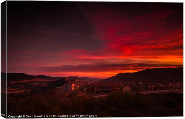 A fiery sunset. Canvas Print by Sean Needham