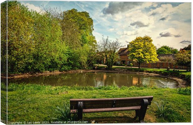 A Seat By The Village Pond Canvas Print by Ian Lewis