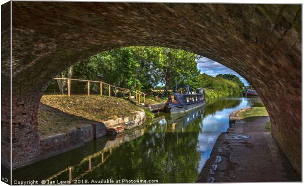 Under The Bridge At Pewsey Wharf Canvas Print by Ian Lewis