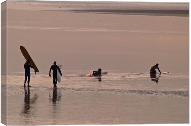 Surfers walking out to water with surfboards Canvas Print by mark humpage