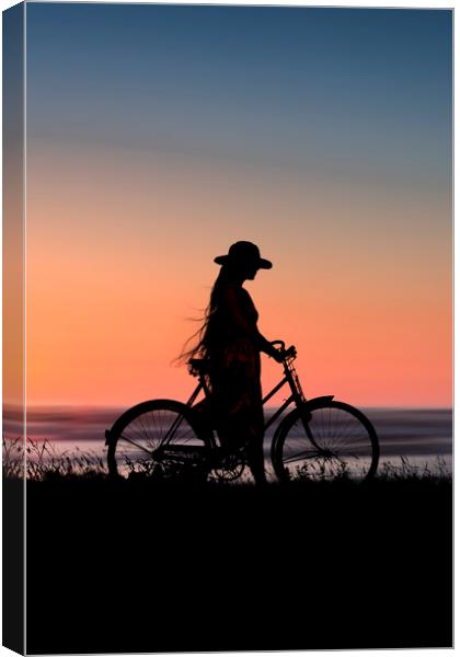 Silhouette Of Girl And Bike At Sunset Near The Sea Canvas Print by Maggie McCall