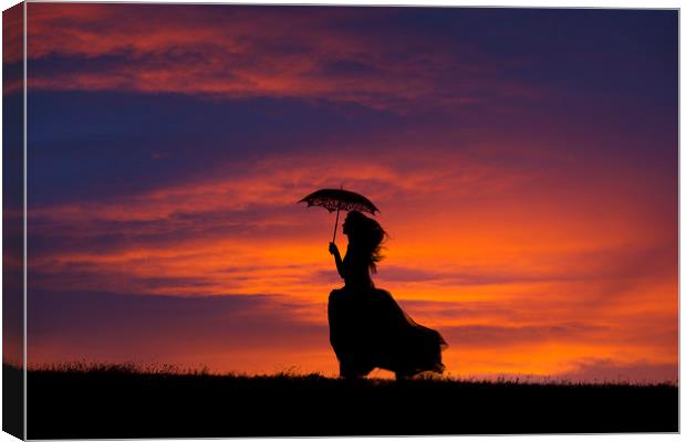 Silhouette of young woman running at sunset Canvas Print by Maggie McCall