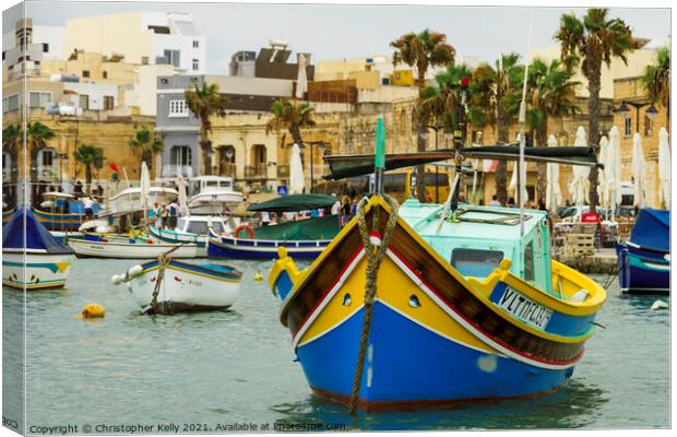 A small boats moored in marsaxlokk bay Canvas Print by Christopher Kelly