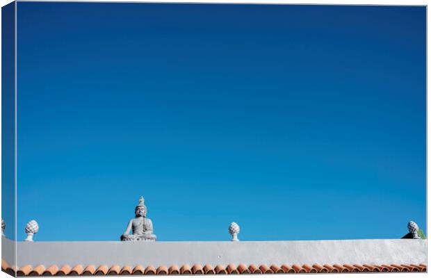 Buddha figure on roof Canvas Print by Phil Crean