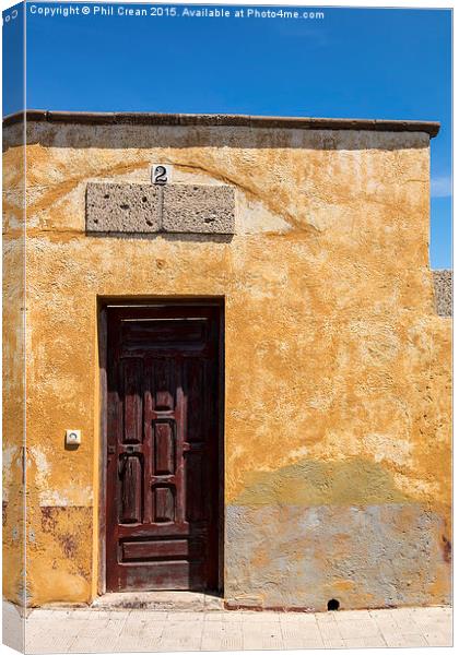  Textured ochre wall, dark red door Tenerife Canvas Print by Phil Crean