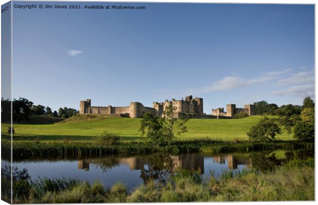 Alnwick Castle reflected in the River Aln Canvas Print by Jim Jones