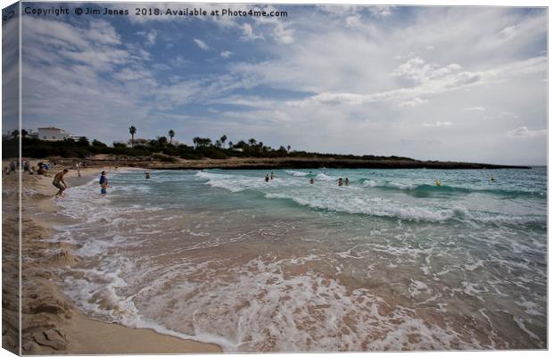 The beach at Cala'n Bosch, Menorca Canvas Print by Jim Jones