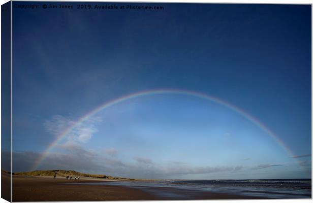 Rainbows over Druridge Bay Canvas Print by Jim Jones