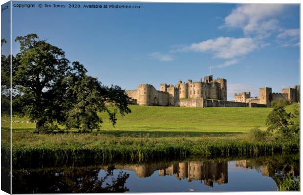 Alnwick Castle reflected in the River Aln Canvas Print by Jim Jones